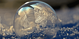 frozen landscape with a ball of decorated ice in the foreground