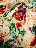 salmon with red onion, tomato and wilted spinach coconut cream sauce