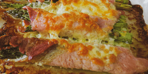 bacon-wrapped asparagus topped with cheese