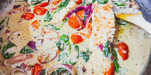 salmon with red onion, tomato and wilted spinach coconut cream sauce