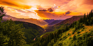 a green valley with golden sunlight streaming down