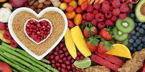 fruits arranged in a heart shape amongst other fruit